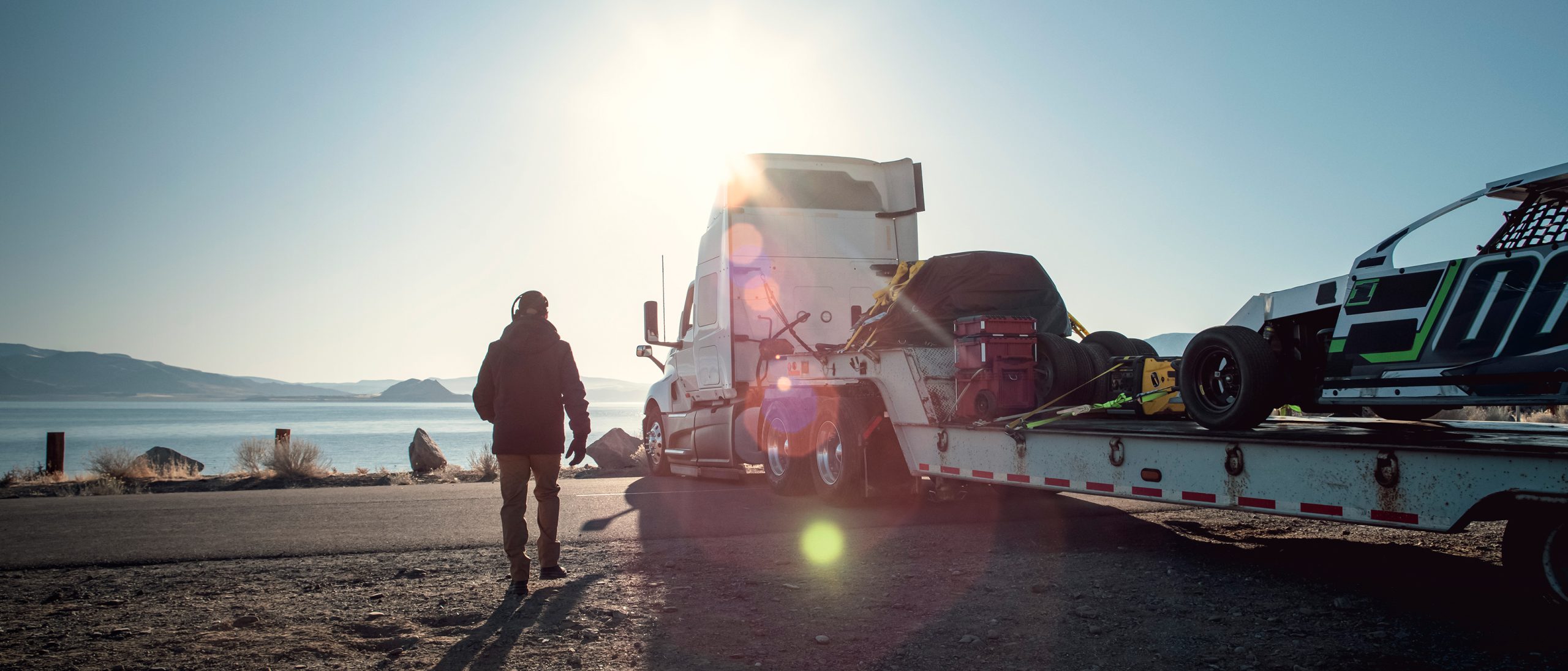 hero_international_proven_trucks_white_truck_by_water_with_driver_walking_to_truck (1)